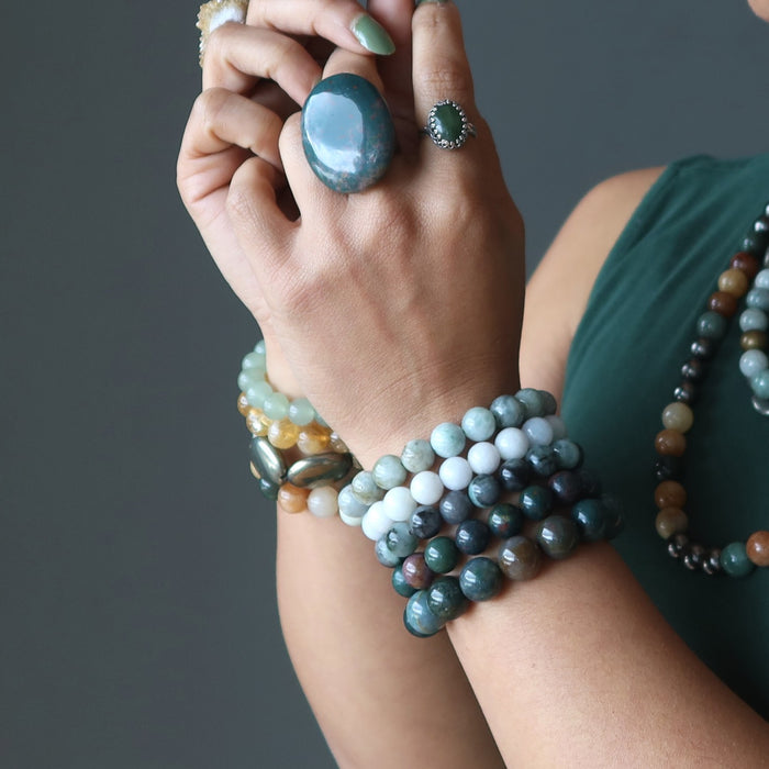 abundance bracelets stacked on wrists