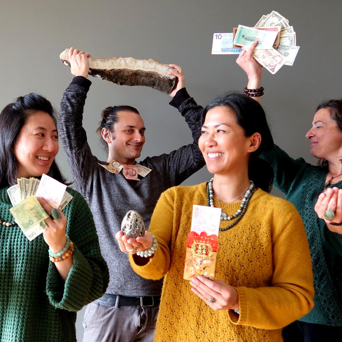 people holding cash and crystals