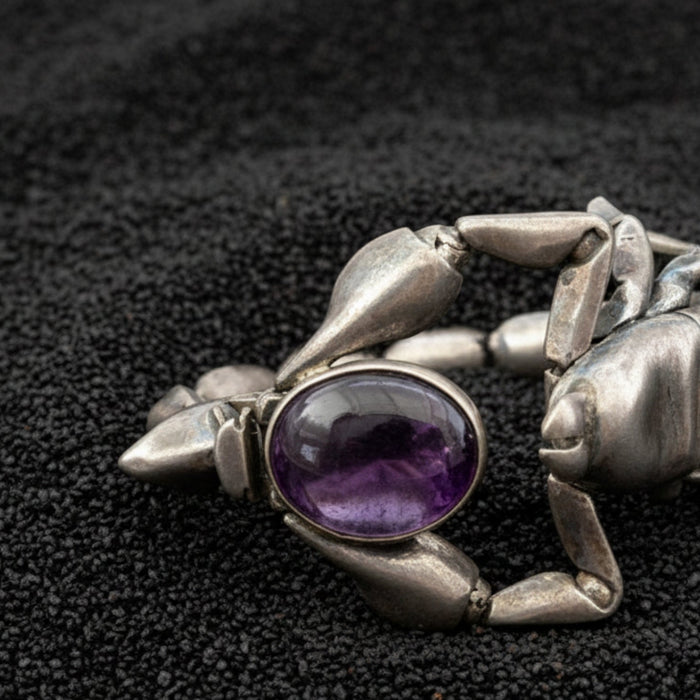 amethyst scorpion bracelet on black sand
