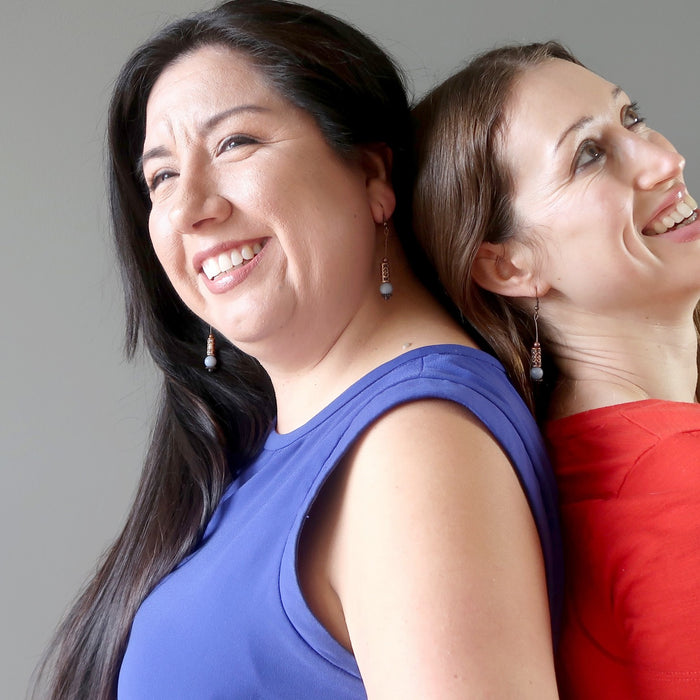 two females leaning back to back