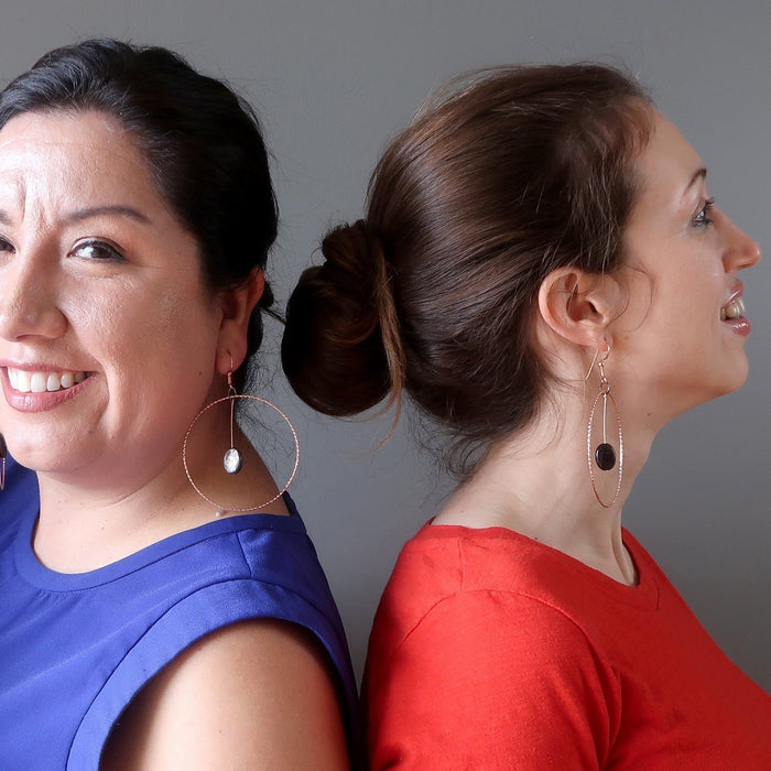 two women wearing mica hoop earrings