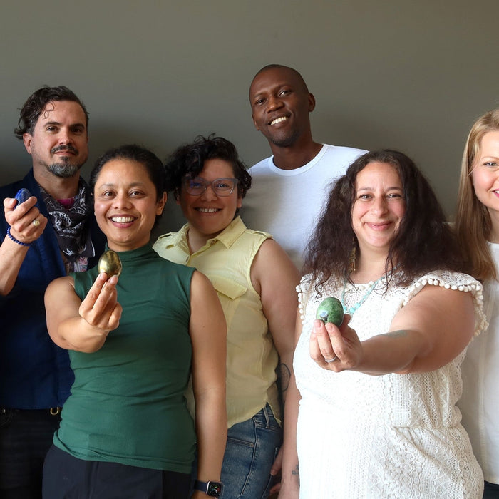 group of people holding crystals eggs