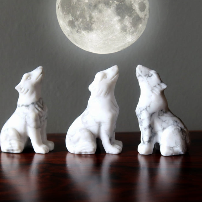 three howlite wolves howling at full moon