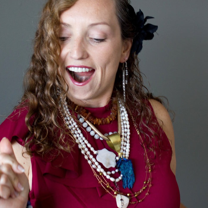 woman wearing crystal necklaces