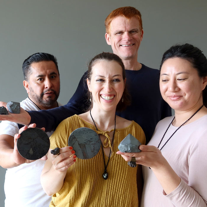 people holding hematite crystals