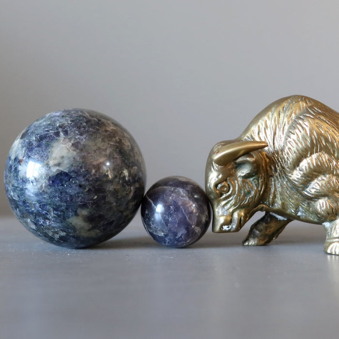 brass bull pushing iolite spheres
