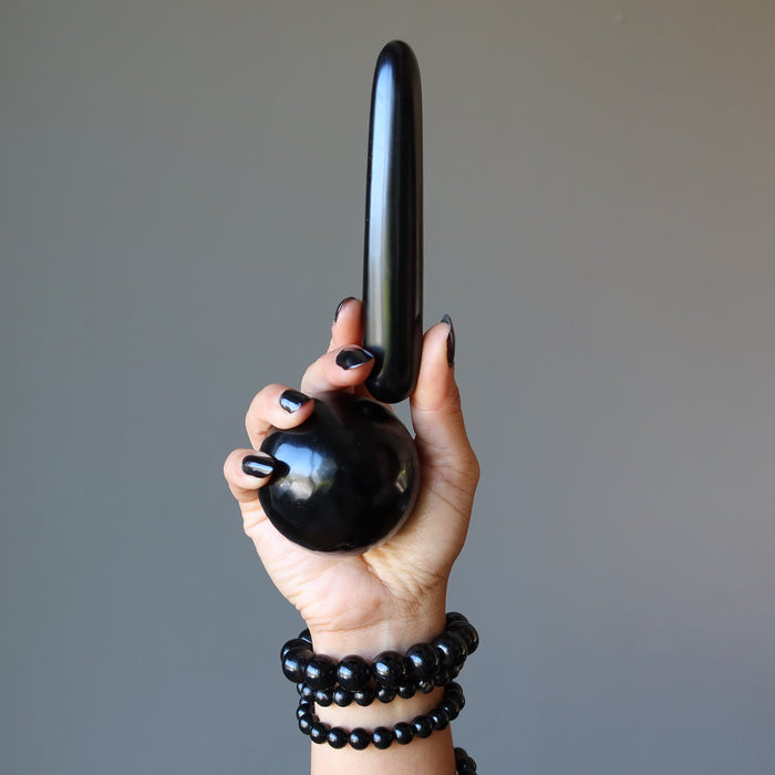 hand wearing and holding jet stones