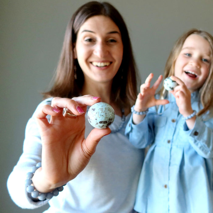 mother daughter holding larimar spheres
