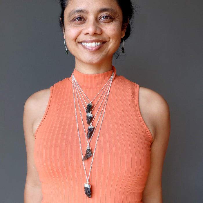 sheila of satin crystals wearing moldavite necklaces and earrings