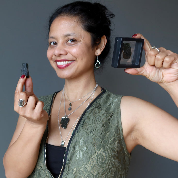 showing off moldavite jewelry and gemstones