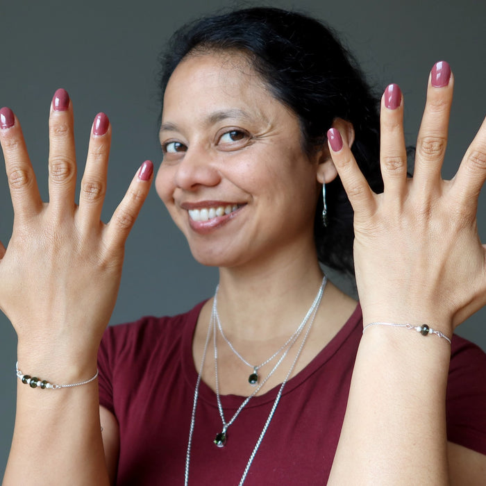 sheila of satin crystals showing off new moldavite jewelry
