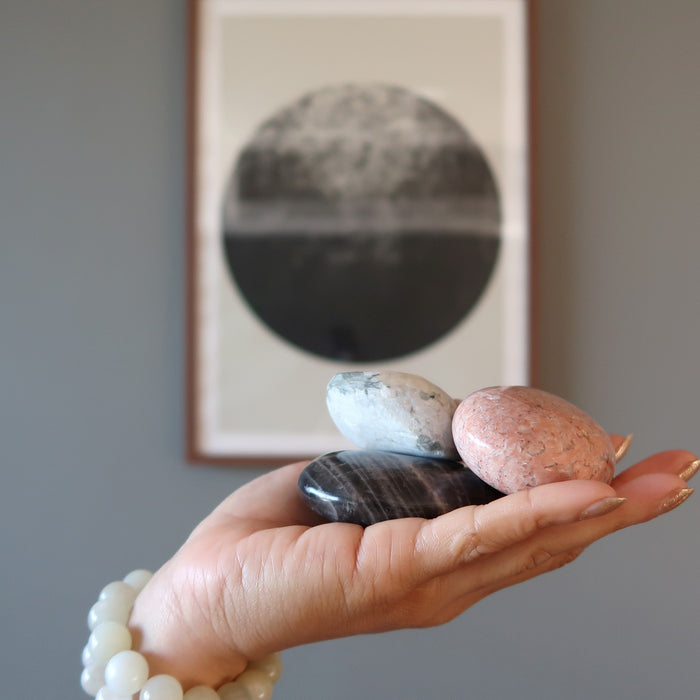 hand holding moonstone stones