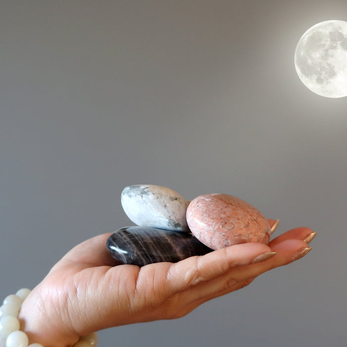 moonstone in hand under full moon