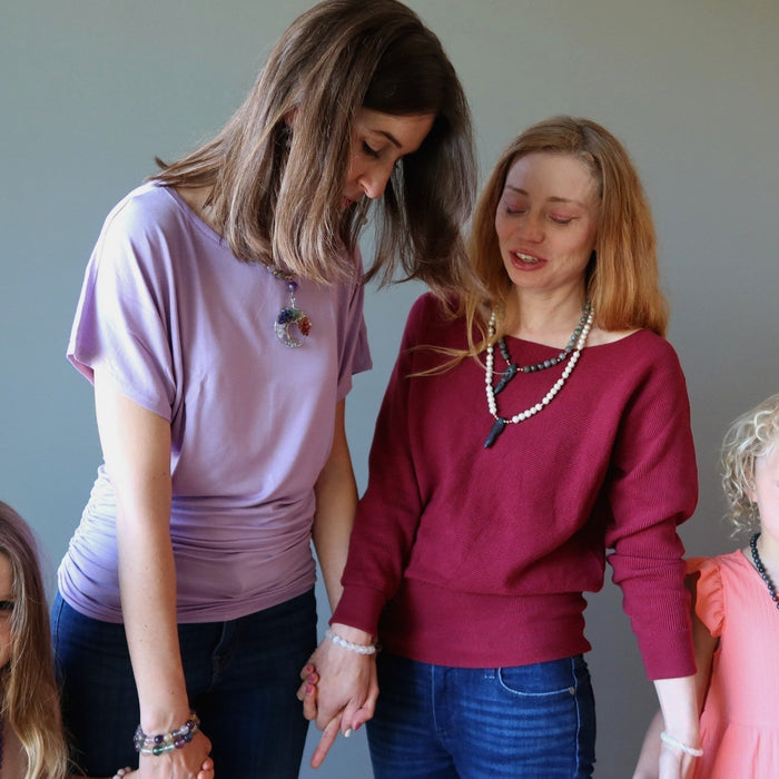 mothers and daughters holding hands