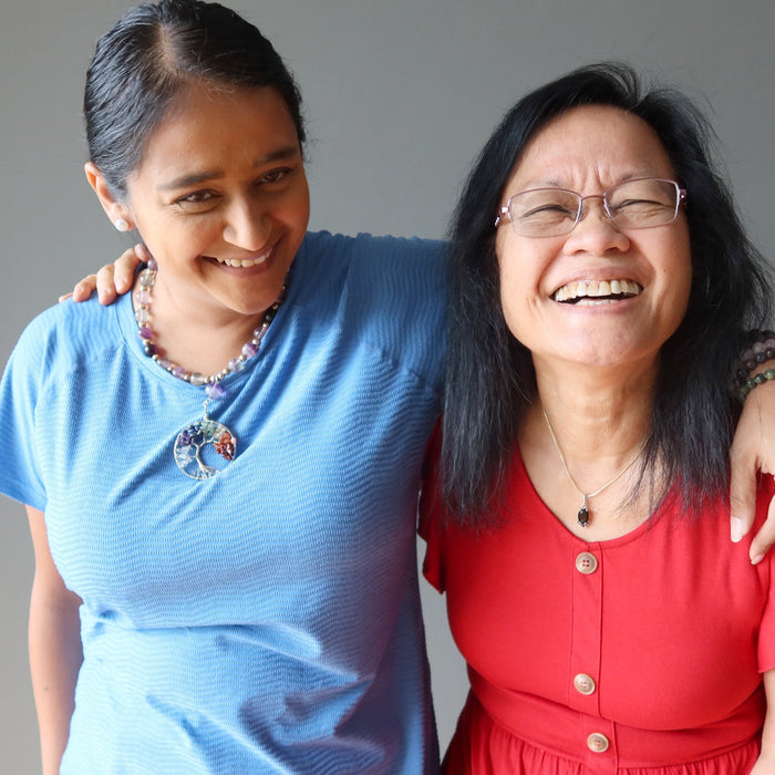 mother and daughter wearing crystal necklaces