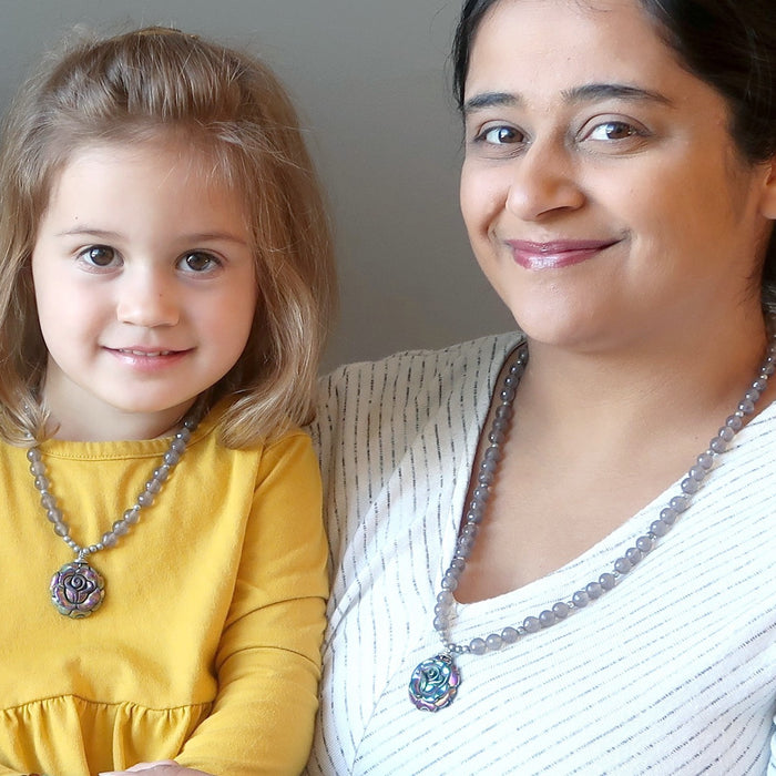 mother and daughter wearing matching crystal healing necklaces