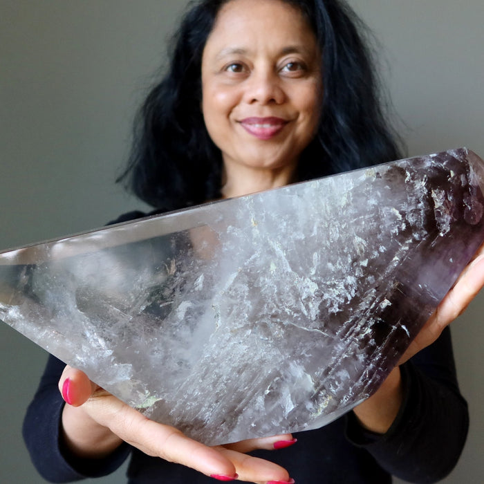 woman holding a quartz showpiece crystal