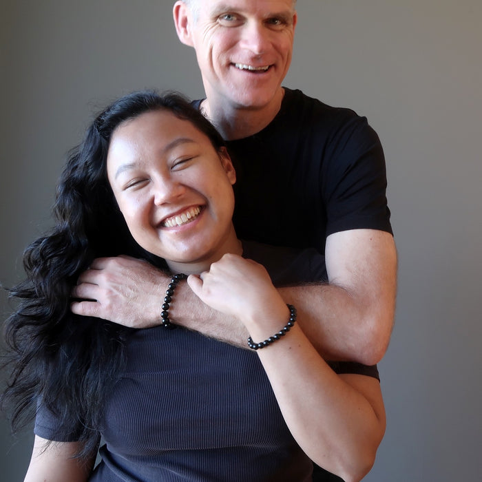 couple wearing black jet bracelets