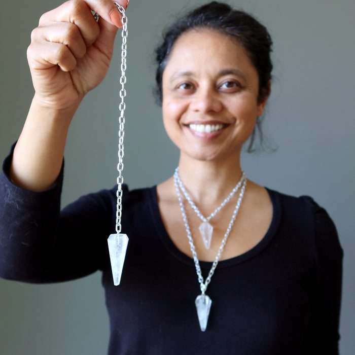 woman holding and wearing convertible quartz pendulum necklaces