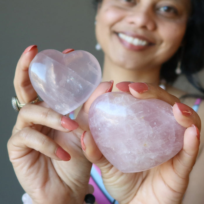 sheila of satin crystals holding two pink rose quartz hearts