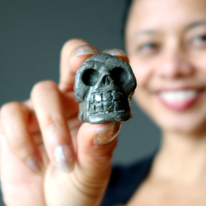 woman holding pyrite skull