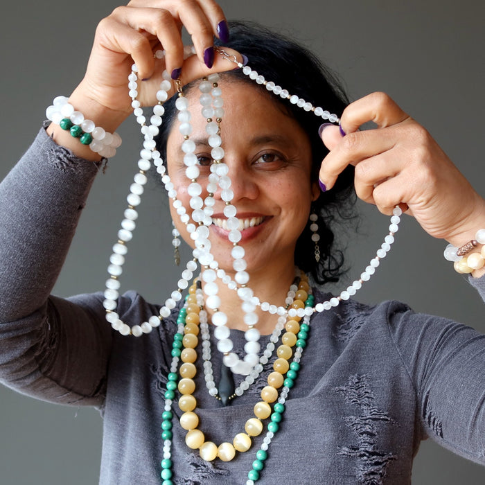 sheila of satin crystals wearing selenite necklaces and bracelets and earrings