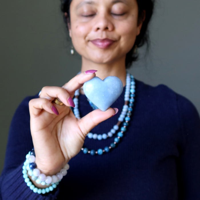 woman with angelite heart at throat chakra