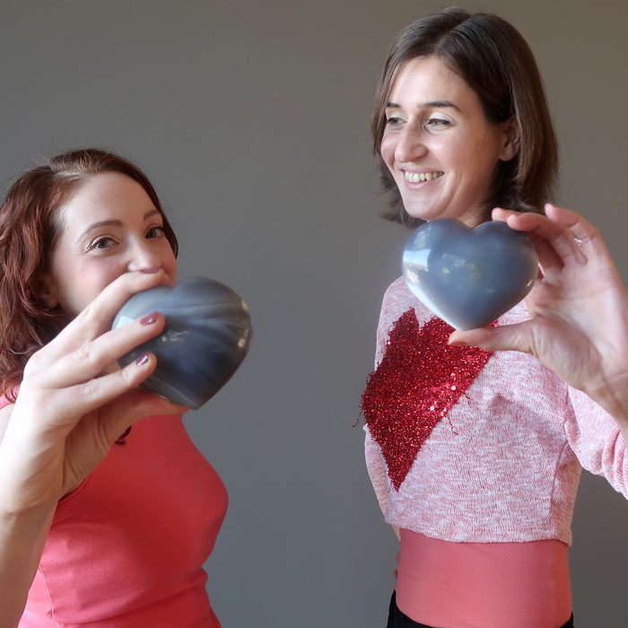 two ladies holding blue agate hearts