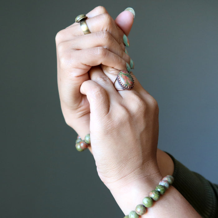 unakite bracelets and rings on hands