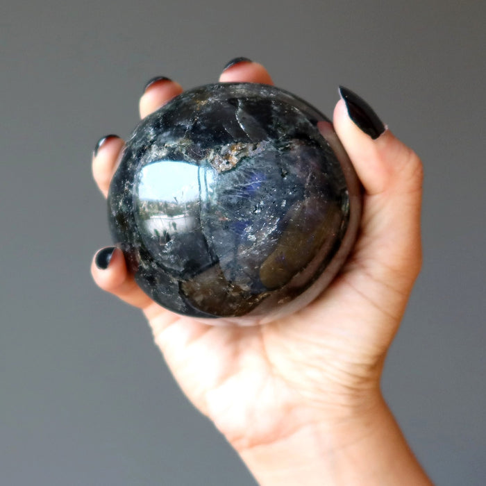 hand holding beyond labradorite ball