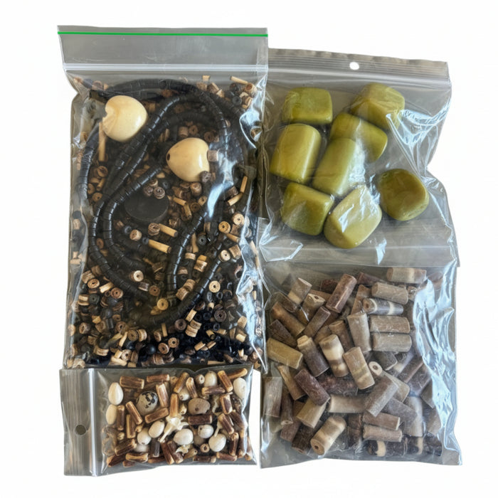 Three clear plastic bags with different types of beads
