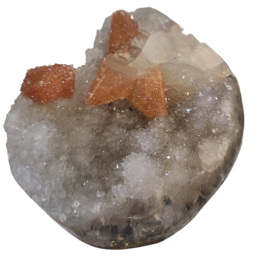 Quartz Geode with orange crystals on a white background