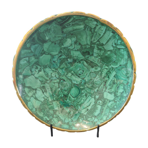 Green malachite specimen on a stand against a gray background