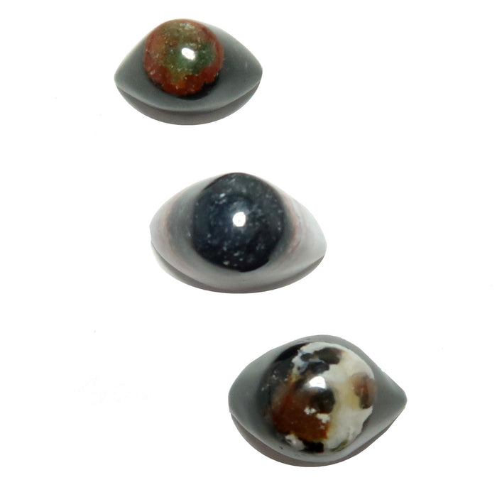 A set of three polished Sardonyx Agate stones shaped like eyes, displaying various colors including black, brown, and red.