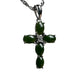Green jade cross pendant necklace on a textured surface