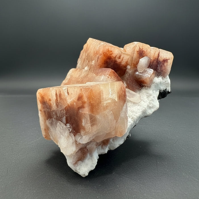 Hand holding a crystal with a blurred indoor background