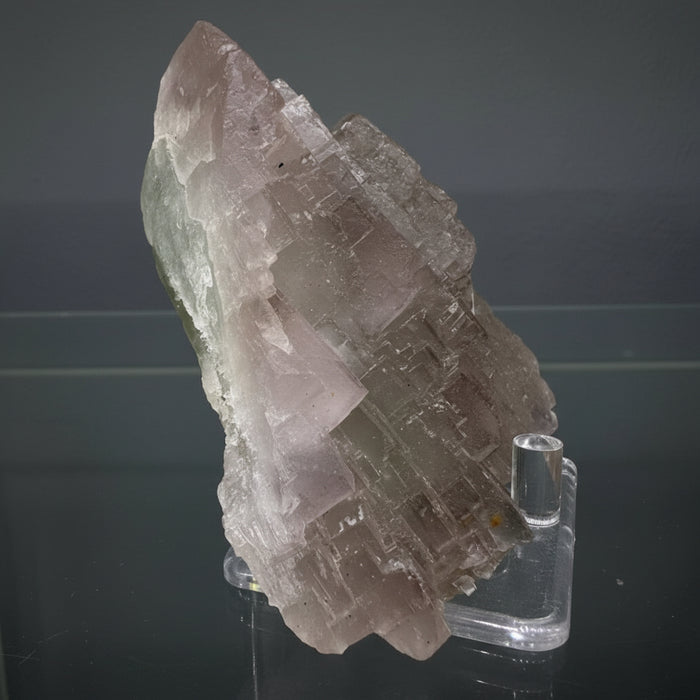 Crystal or mineral specimen on a reflective surface