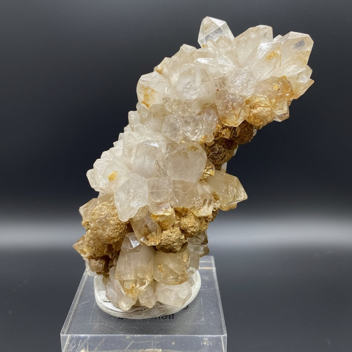 Crystal cluster on a stand with a reflective background
