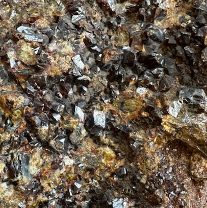 Close-up of a mineral sample with crystals on a rock surface