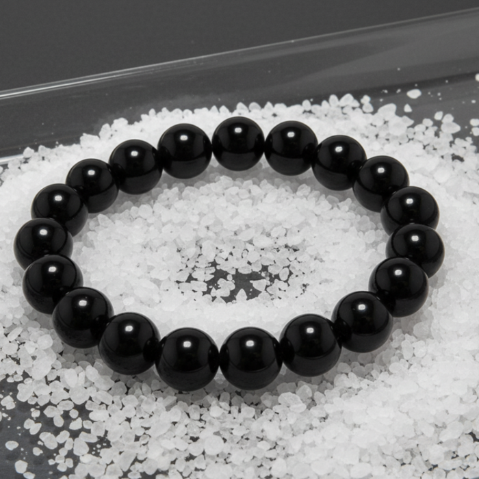 Black onyx beaded bracelet on a textured white salt