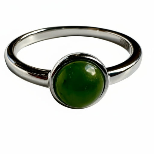 Silver ring with a green gemstone on a white background
