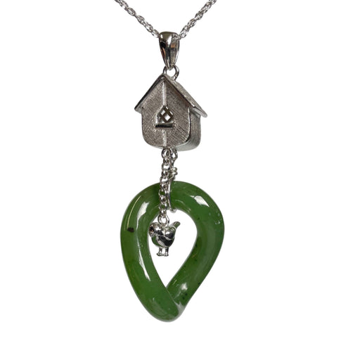 Green jade pendant with silver birdhouse and bird charm on a white background