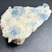 Crystal rock with blue crystals on a dark gray background