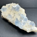 Crystal rock with blue crystals on a dark gray background