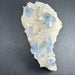 Crystal rock with blue and clear crystals on a dark gray background