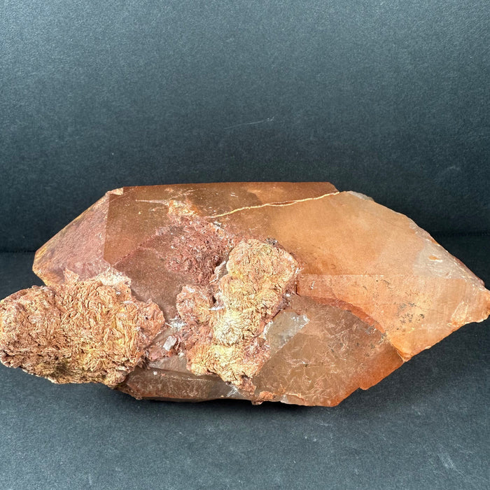 tangering quartz crystal on a dark gray background