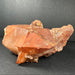 Red-orange quartz crystal on a dark gray background