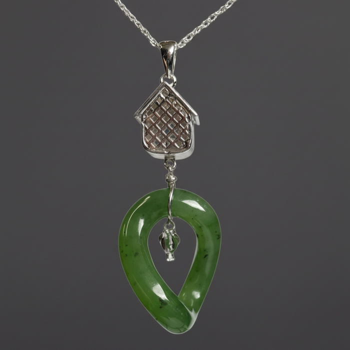 Green jade pendant with silver chain on a white background