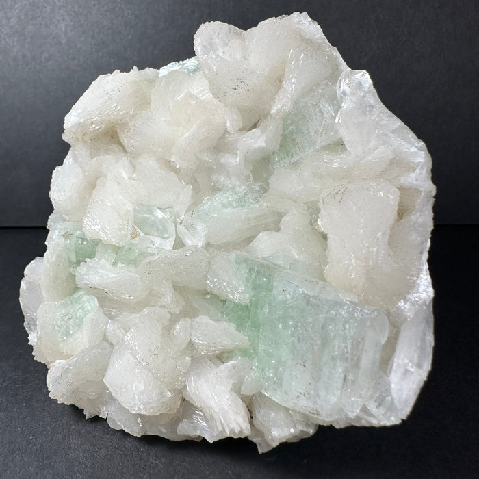 Crystal rock with green and white colors on a dark background