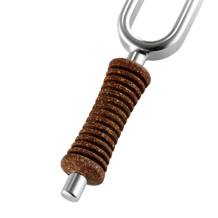 Metallic tuning fork with brown textured grip on a white background
